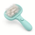 Teal self-cleaning slicker brush with release button